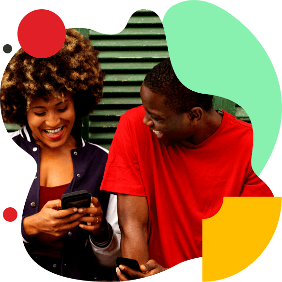 Young woman and man laughing as the woman looks down at her cell phone.
